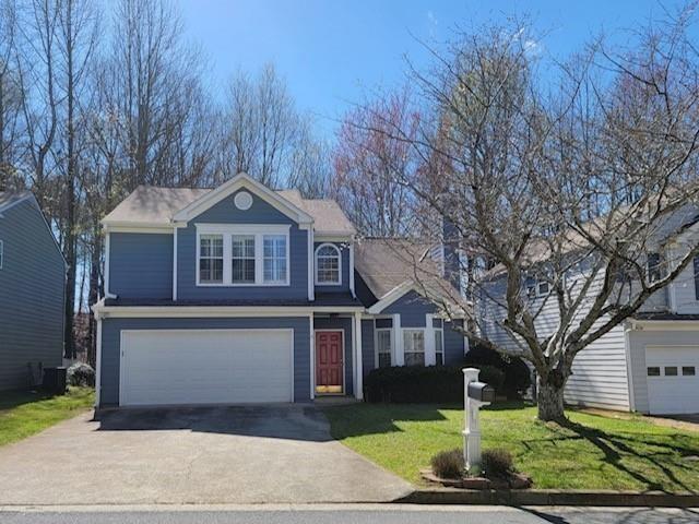 a front view of house with yard and green space