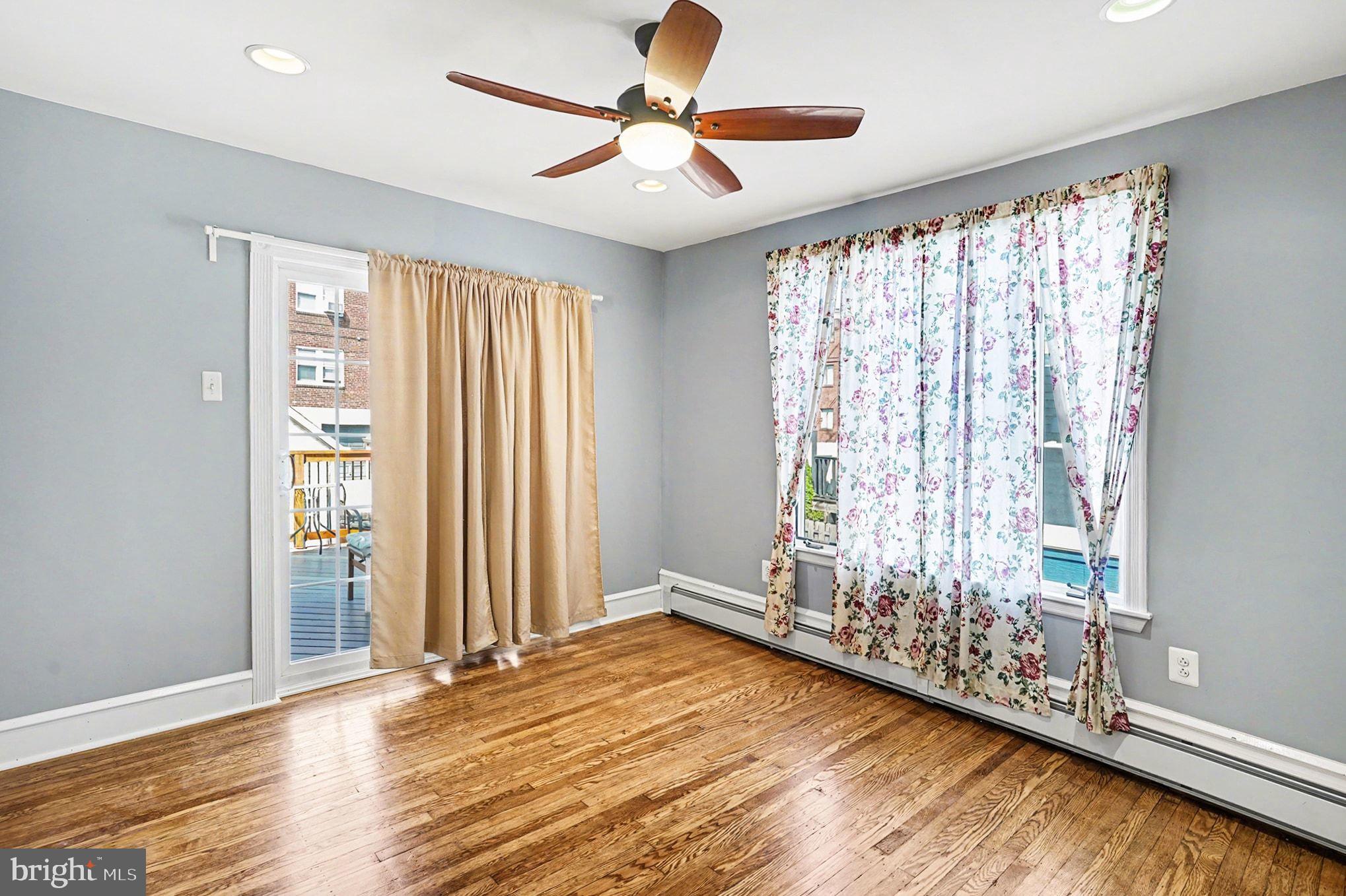 4031 Vernon Road Drexel Hill, PA 19026 - Photo 12 of 38 a view of an empty room with a window and hardwood floor