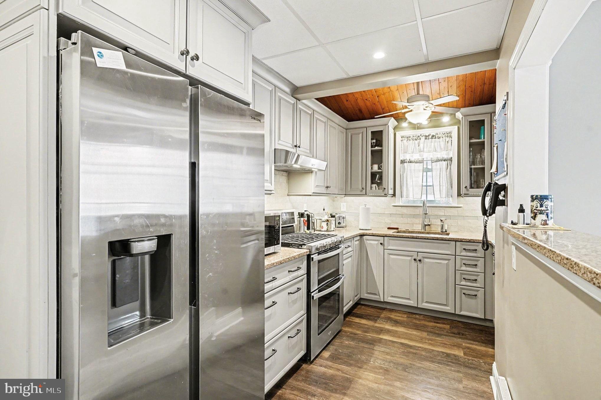 4031 Vernon Road Drexel Hill, PA 19026 - Photo 15 of 38 a kitchen with stainless steel appliances granite countertop cabinets a sink and a refrigerator