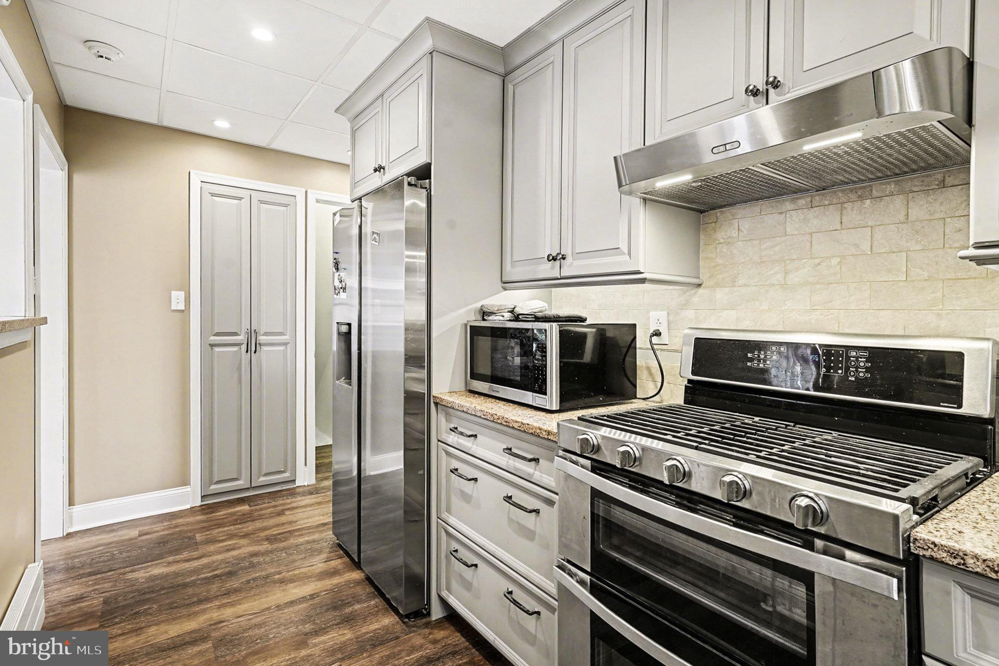 4031 Vernon Road Drexel Hill, PA 19026 - Photo 17 of 38 a kitchen with a stove and a microwave