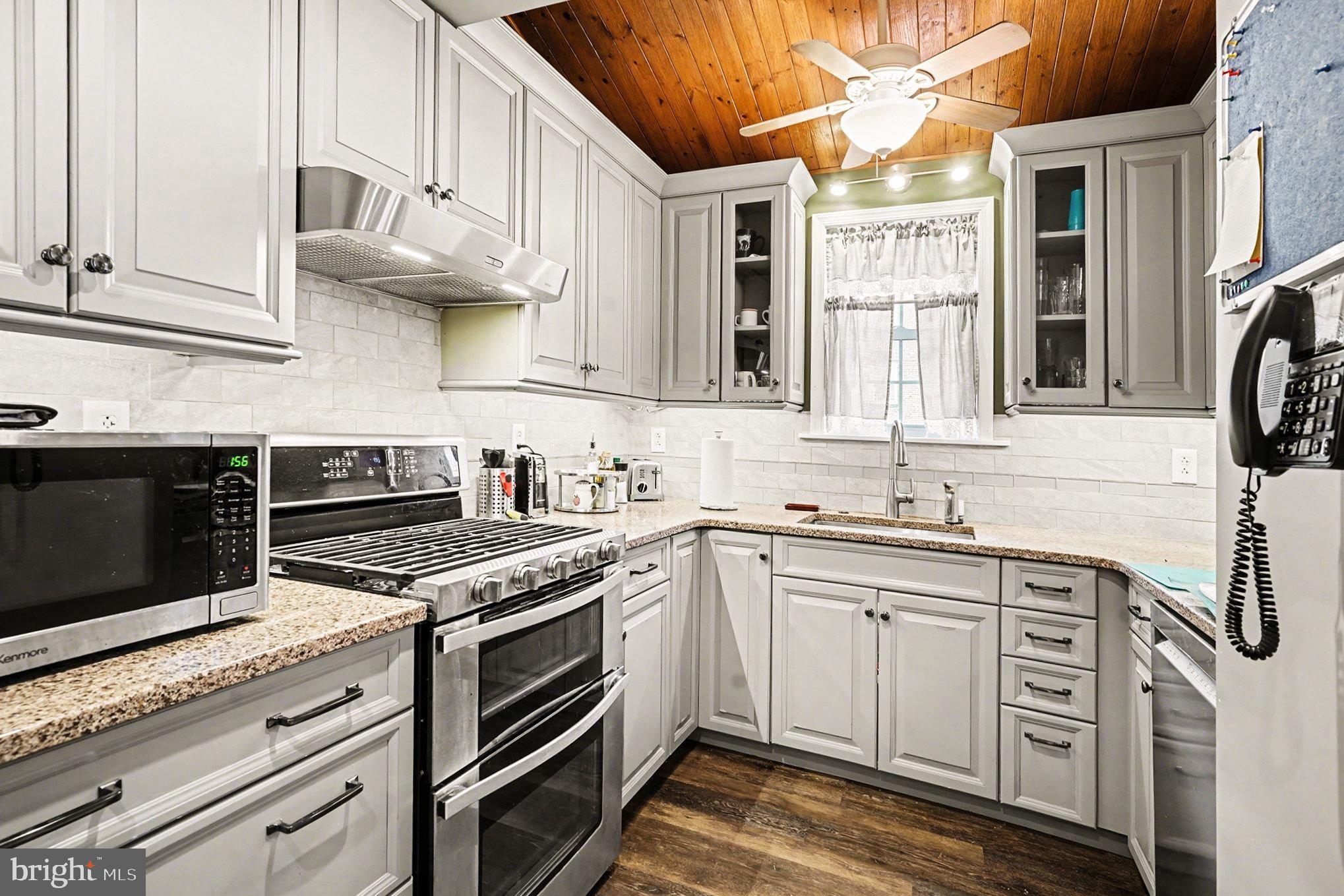 4031 Vernon Road Drexel Hill, PA 19026 - Photo 19 of 38 a kitchen with stainless steel appliances granite countertop a stove and a sink