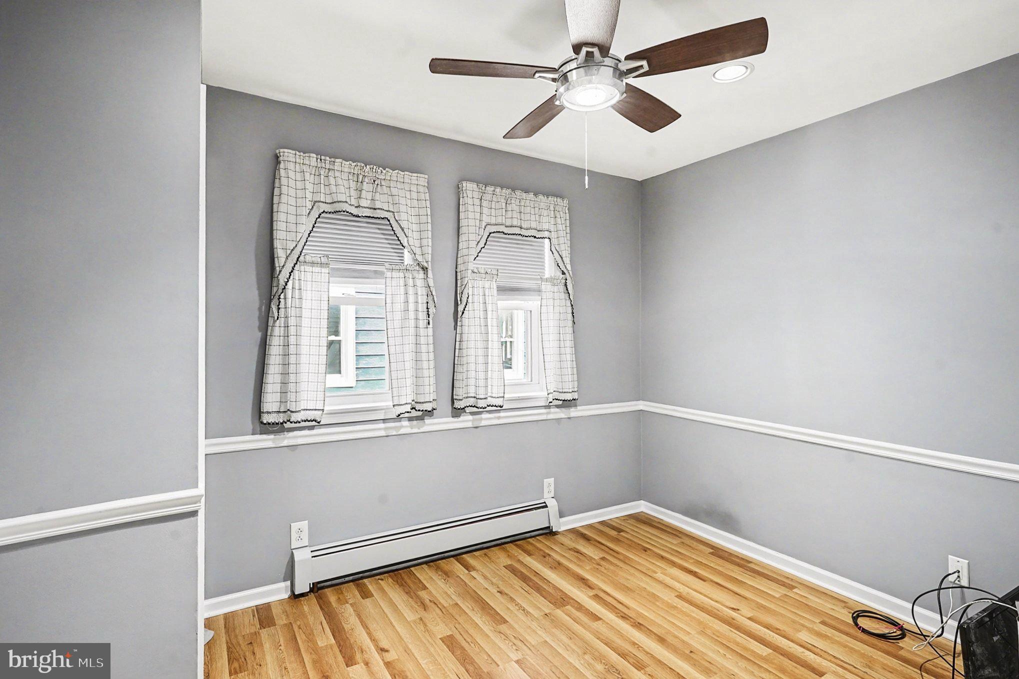 4031 Vernon Road Drexel Hill, PA 19026 - Photo 24 of 38 a view of an empty room with a window and a chandelier fan