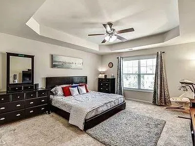 a bedroom with a large bed and a window