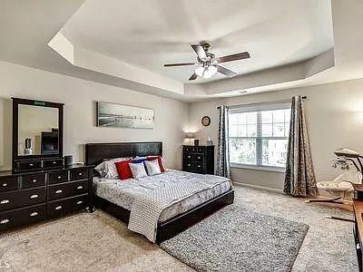 4645 Cold Spring Court Cumming, GA 30041 - Photo 13 of 23 a bedroom with a large bed and a window