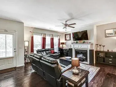 a living room with furniture a fireplace and a flat screen tv