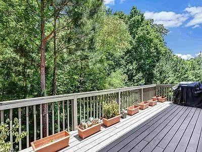 4645 Cold Spring Court Cumming, GA 30041 - Photo 19 of 23 a balcony with wooden floor and fence