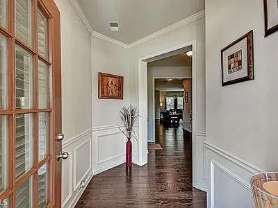 4645 Cold Spring Court Cumming, GA 30041 - Photo 5 of 23 a view of a hallway with wooden floor and staircase
