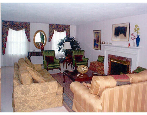 5 Seminole Road Canton, MA 02021 - Photo 3 of 5 a living room with furniture a fireplace and a flat screen tv