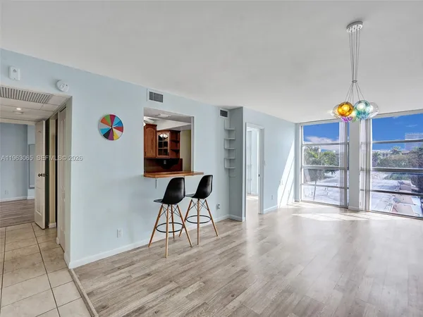 a view of a livingroom with wooden floor and furniture