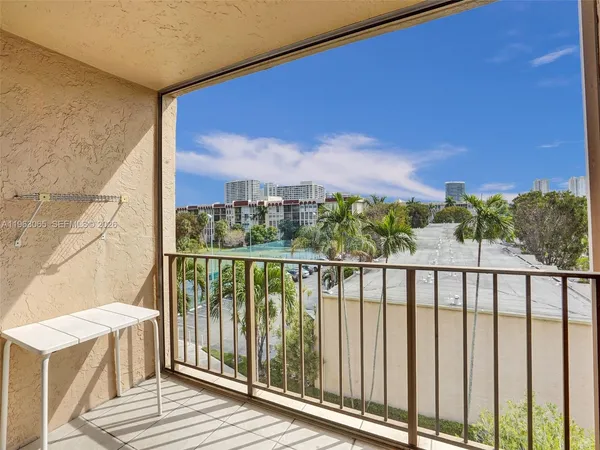 a view of a balcony with wooden floor and city view