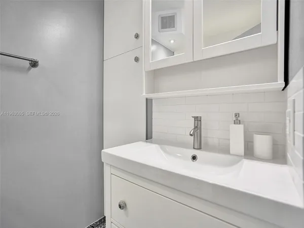a bathroom with a sink and mirror