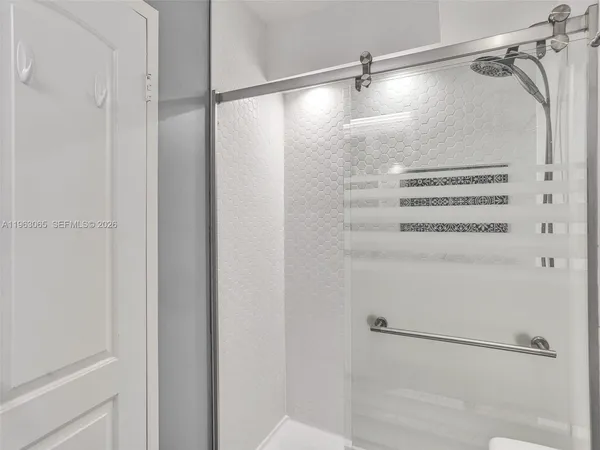 a bathroom with a glass shower door