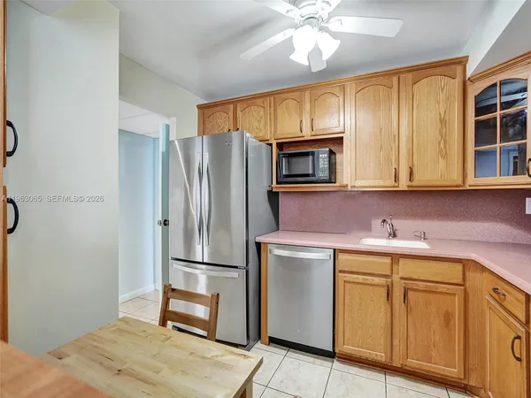 a kitchen with a sink stainless steel appliances and cabinets