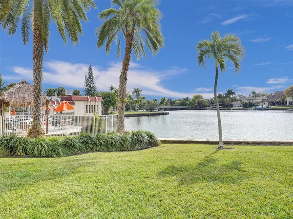 a house with swimming pool and a lake view