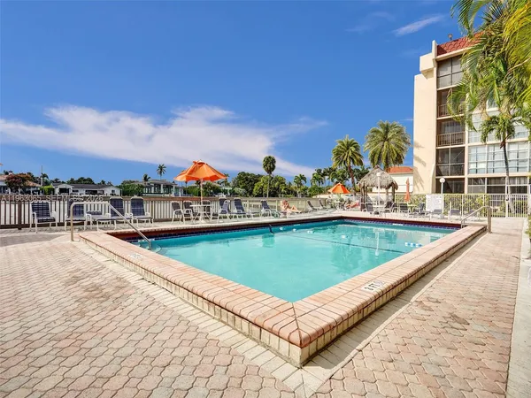 a view of a swimming pool with a lounge chair
