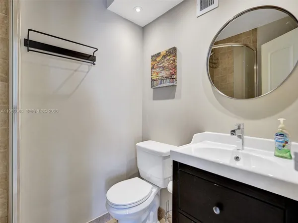 a bathroom with a toilet sink and mirror