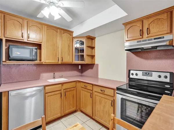 a kitchen with stainless steel appliances granite countertop a sink and cabinets