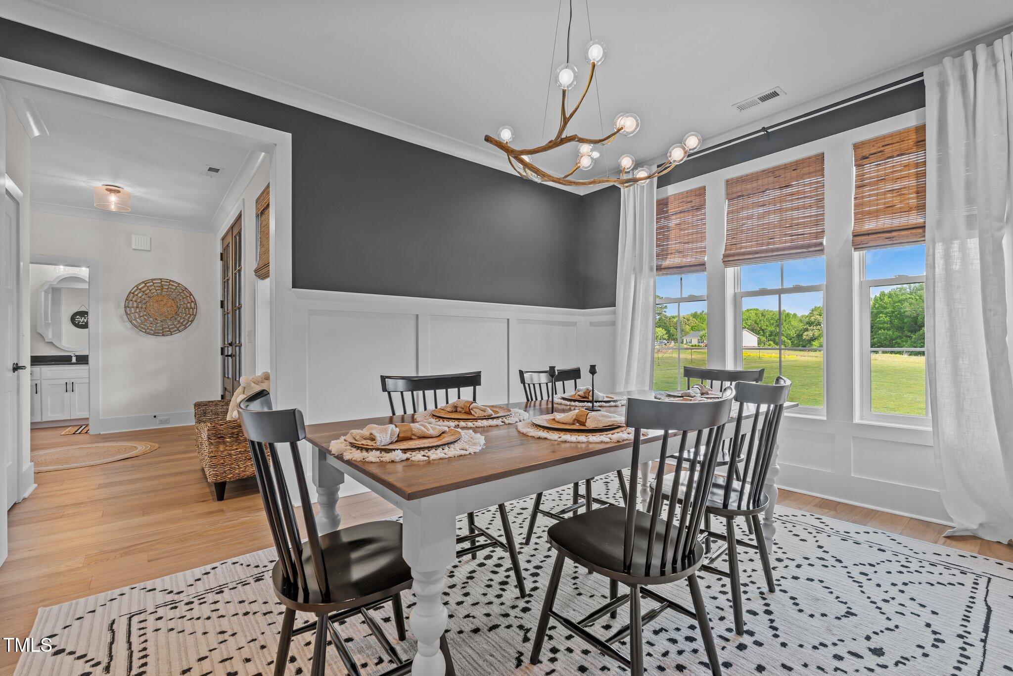 2408 Eddie Howard Road Willow Spring, NC 27592 - Photo 17 of 69 a view of a dining room with furniture window and wooden floor