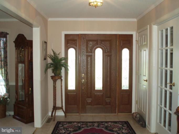 1170 Taylor Road Street, MD 21154 - Photo 11 of 30 Ceramic foyer displays beautiful wood front door