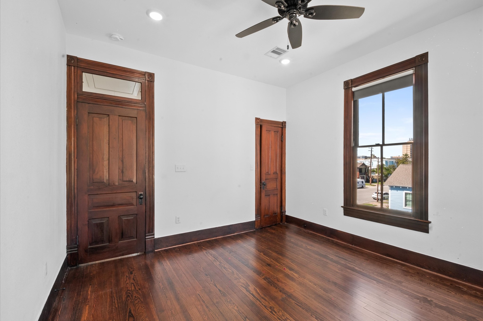 902 9th Street Galveston, TX 77550 - Photo 18 of 38 an empty room with wooden floor ceiling fan and windows