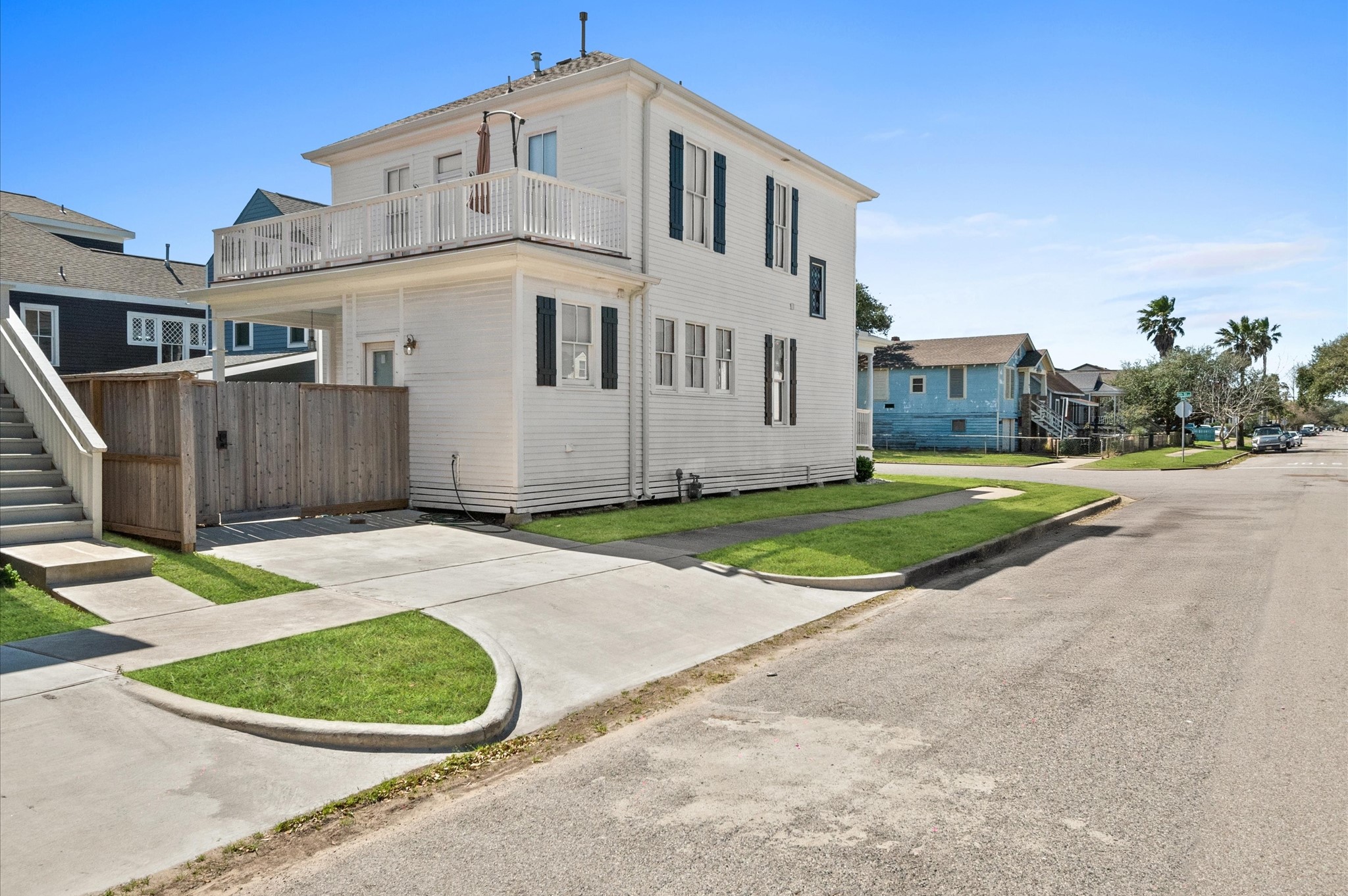 902 9th Street Galveston, TX 77550 - Photo 33 of 38 a view of a white house with a yard and wooden fence