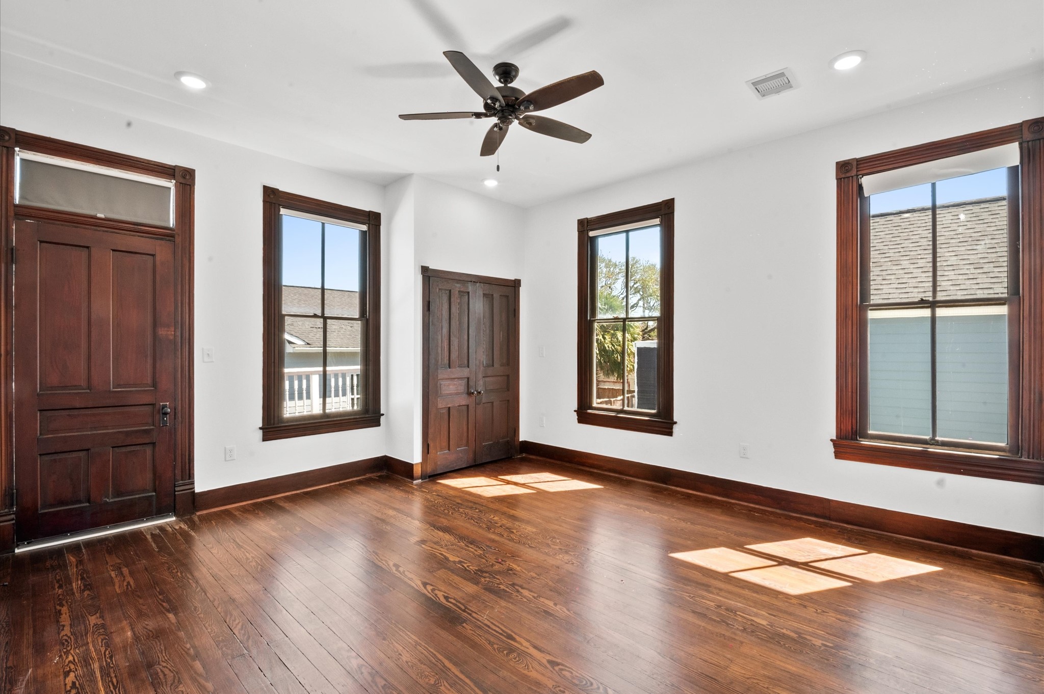 902 9th Street Galveston, TX 77550 - Photo 6 of 38 a view of an empty room with a window and wooden floor