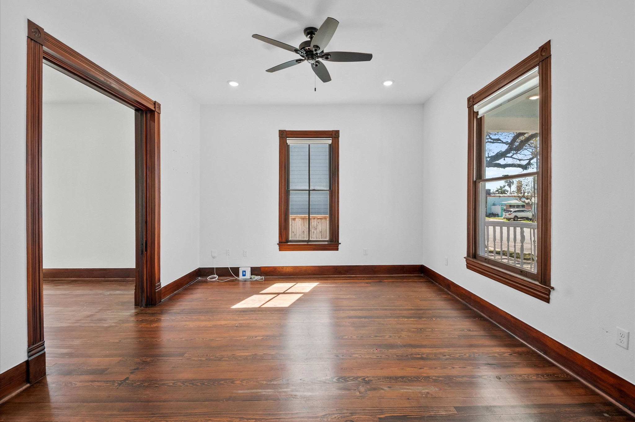902 9th Street Galveston, TX 77550 - Photo 9 of 38 a view of an empty room with a window and wooden floor