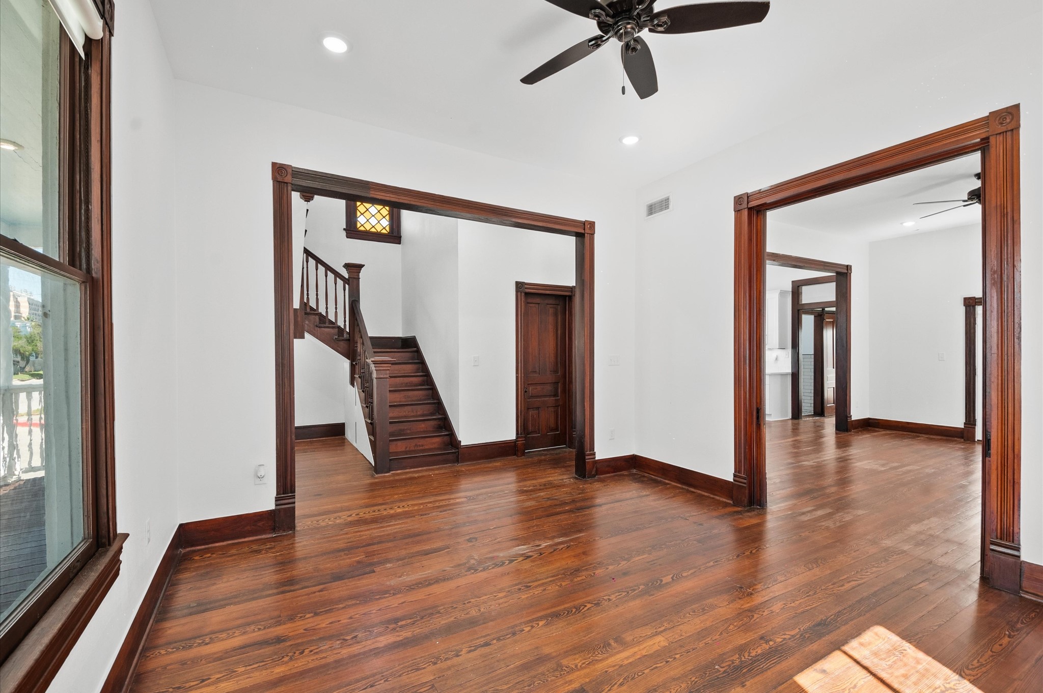 902 9th Street Galveston, TX 77550 - Photo 10 of 38 a view of an empty room with wooden floor and a window