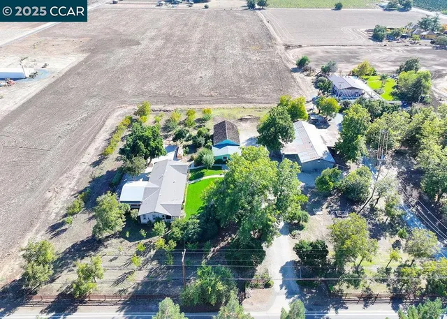 an aerial view of a house with a yard and garden