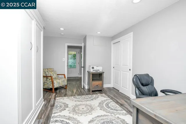 a kitchen with stainless steel appliances granite countertop wooden floors a stove and a refrigerator