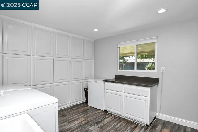 a bathroom with a granite countertop toilet and a sink