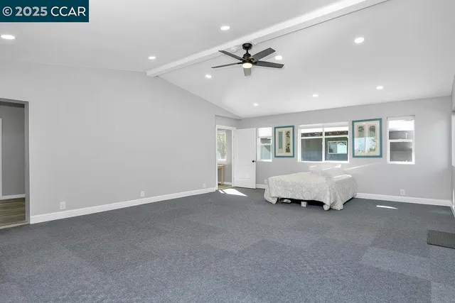 a bathroom with a granite countertop toilet sink and mirror