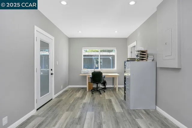 a living room with furniture and large windows