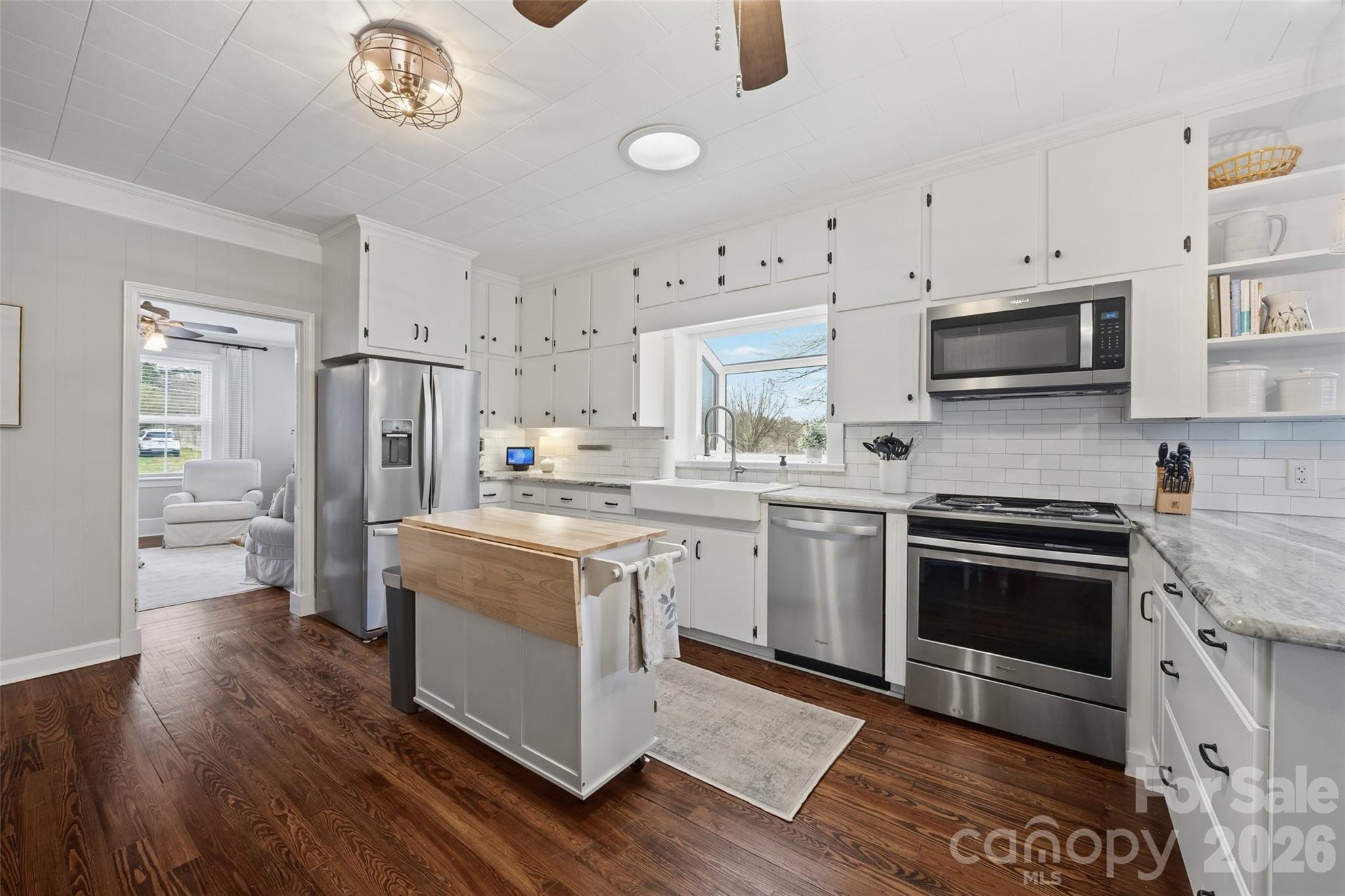 411 Williamson Street Fort Mill, SC 29715 - Photo 13 of 40 a kitchen with a stove a sink and a refrigerator
