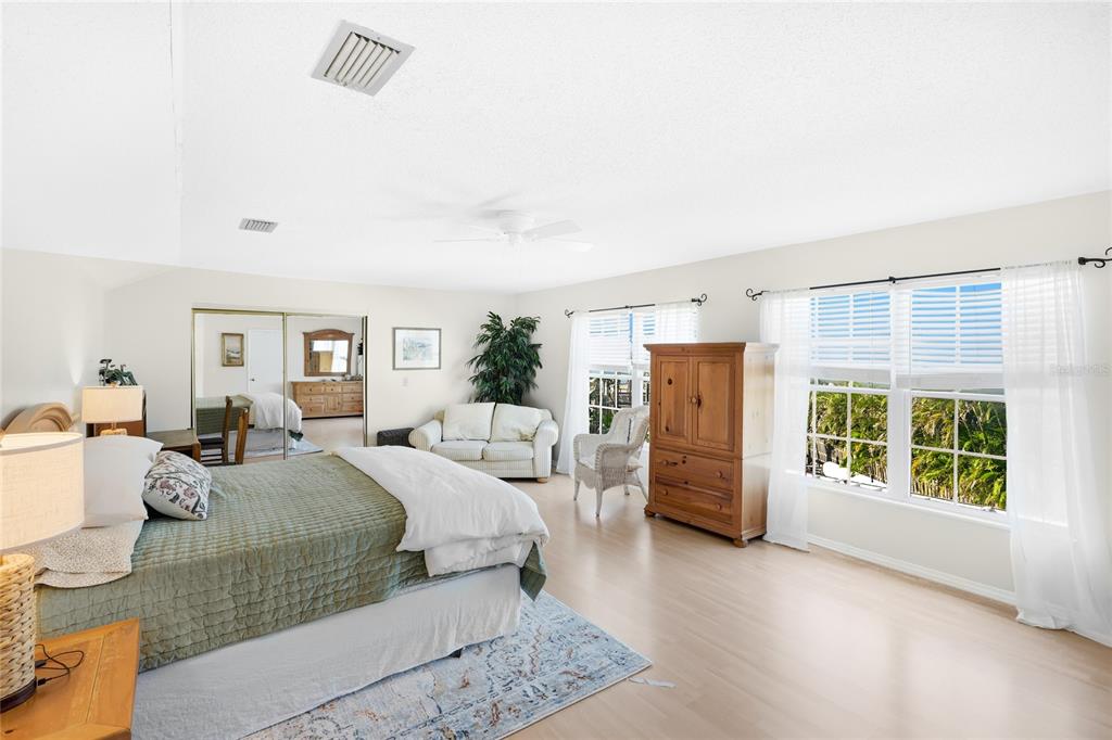 212 85th Street Holmes Beach, FL 34217 - Photo 12 of 45 a bedroom with furniture and a window