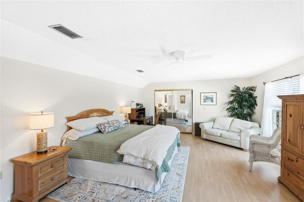 212 85th Street Holmes Beach, FL 34217 - Photo 13 of 45 a bedroom with furniture and a fireplace