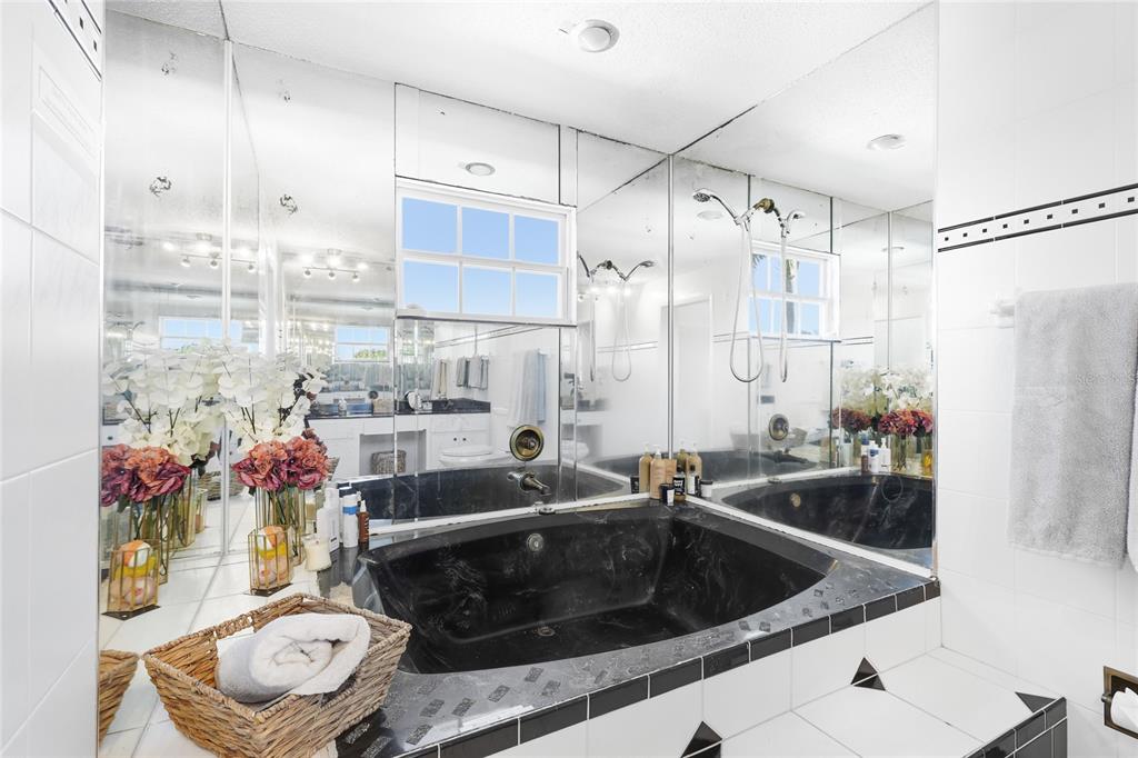 212 85th Street Holmes Beach, FL 34217 - Photo 16 of 45 a kitchen with stainless steel appliances granite countertop a sink and a refrigerator