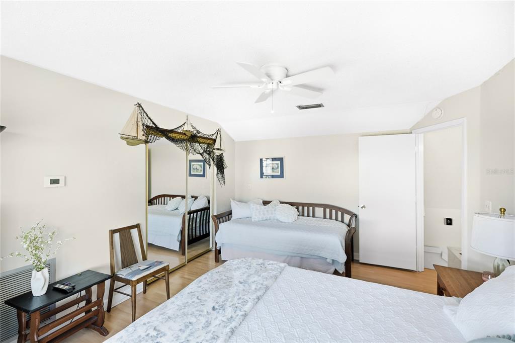 212 85th Street Holmes Beach, FL 34217 - Photo 19 of 45 a bedroom with furniture and a window