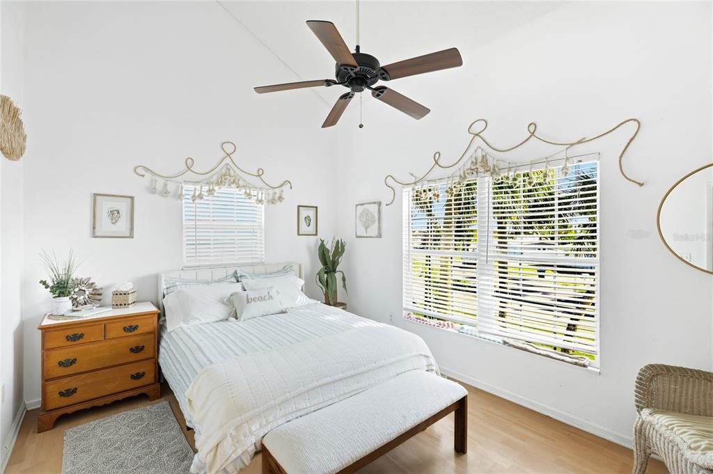 212 85th Street Holmes Beach, FL 34217 - Photo 23 of 45 a bedroom with a bed dresser and a window