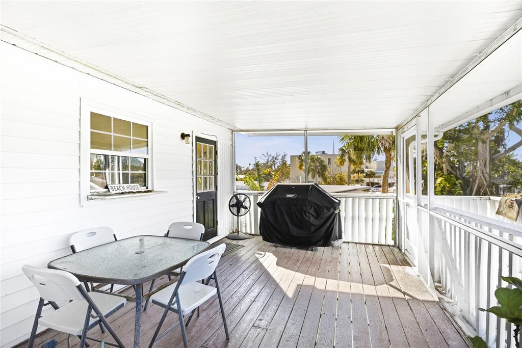 212 85th Street Holmes Beach, FL 34217 - Photo 28 of 45 a bedroom with a bed and wooden floor