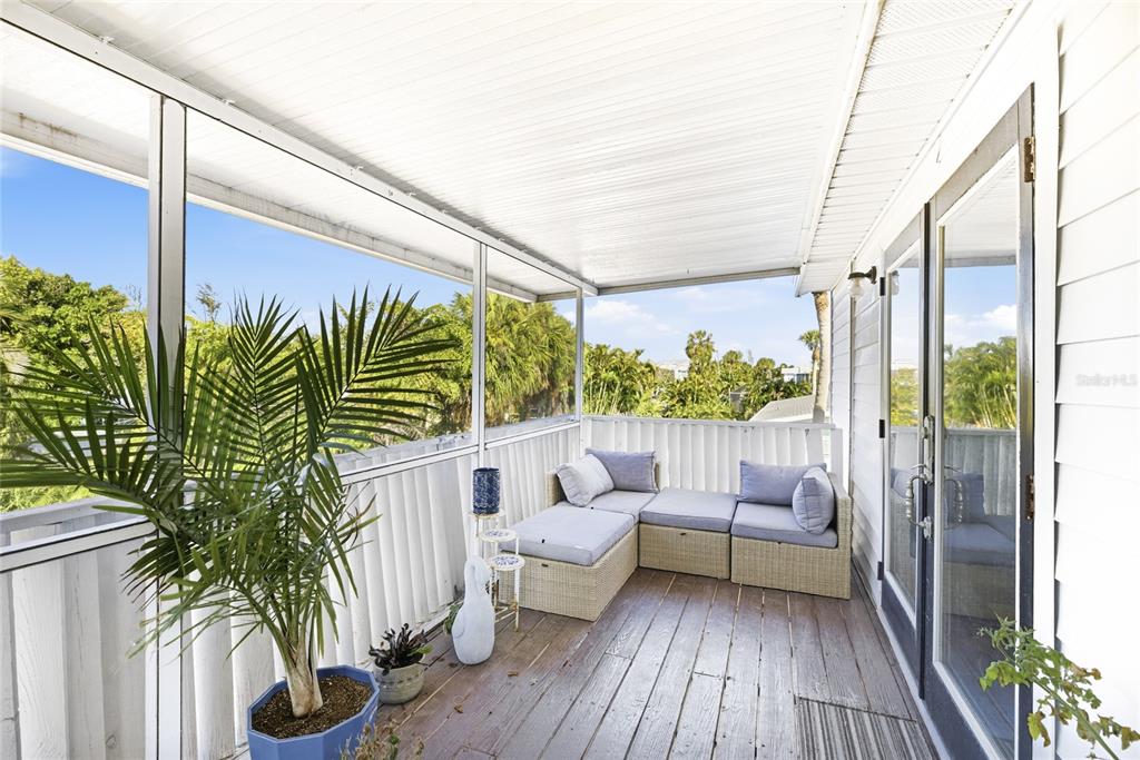212 85th Street Holmes Beach, FL 34217 - Photo 30 of 45 a view of balcony with couch and potted plants