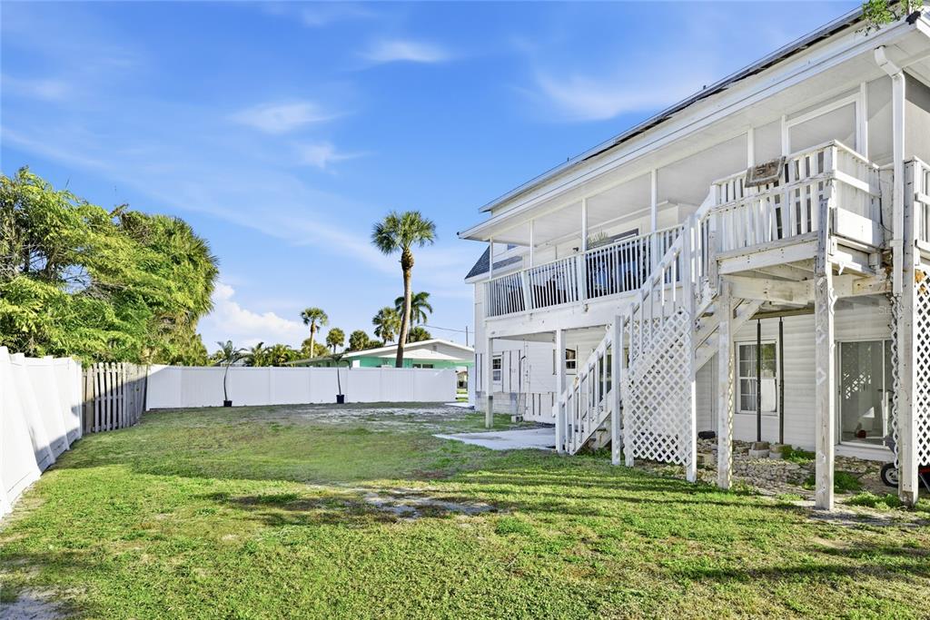 212 85th Street Holmes Beach, FL 34217 - Photo 32 of 45 a view of a big house with a big yard and potted plants