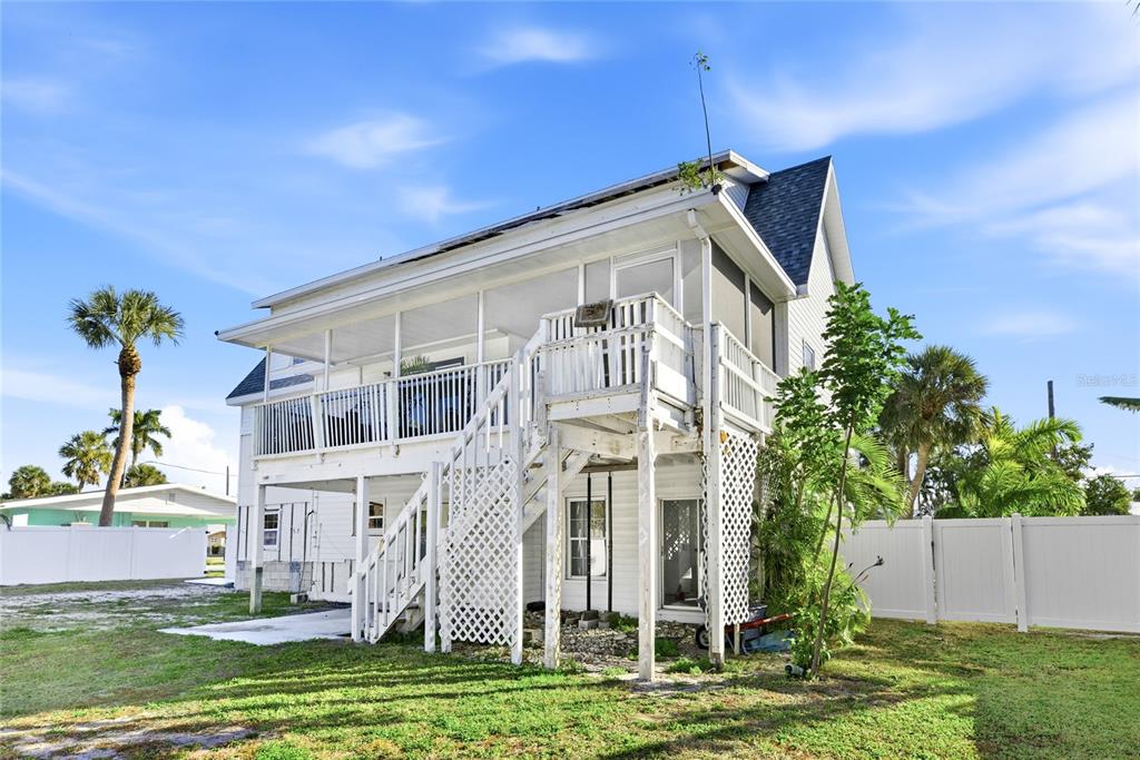 212 85th Street Holmes Beach, FL 34217 - Photo 33 of 45 a front view of a house with a yard