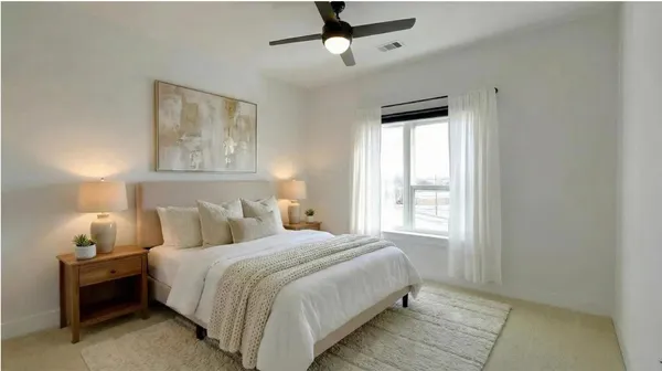 a bedroom with a bed and a window