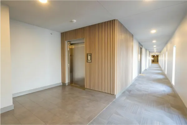 a view of a hallway with wooden shelves