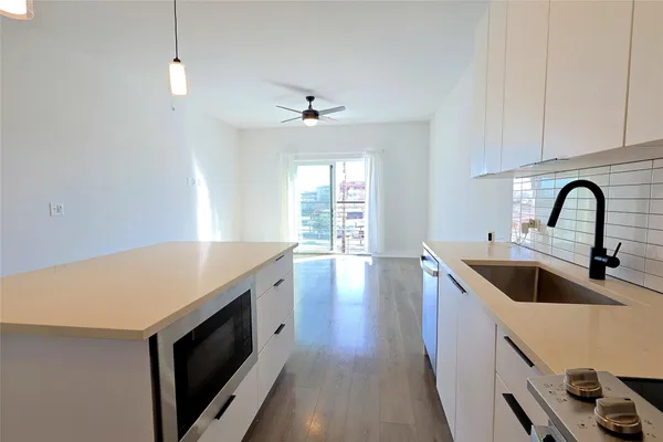 a kitchen with a sink and a hard wood floor
