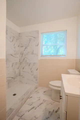a bathroom with a toilet and a shower