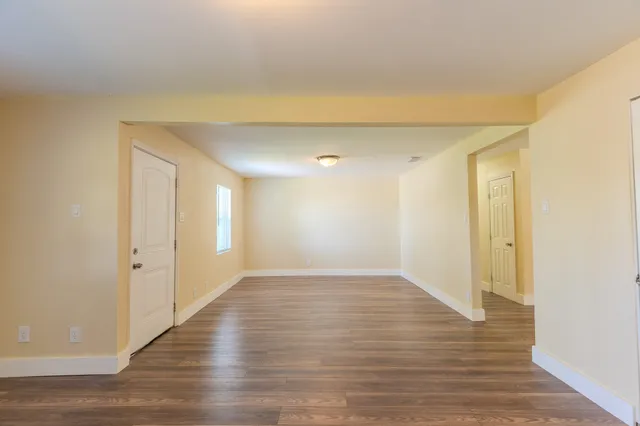 a view of an empty room and wooden floor