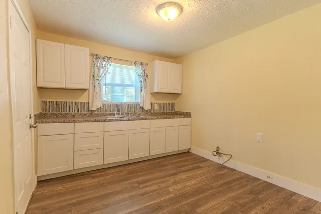 a kitchen with a sink cabinets and window
