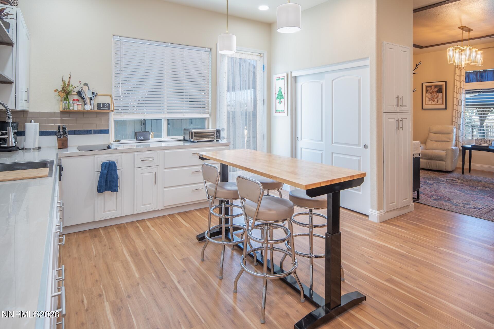 520 Stonehaven Court Dayton, NV 89403 - Photo 22 of 40 a kitchen with stainless steel appliances granite countertop a stove a sink dishwasher and a refrigerator with wooden floor